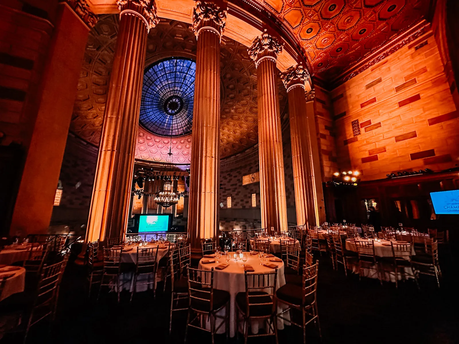 Gotham Hall New York charity gala with grand columns and amber uplighting