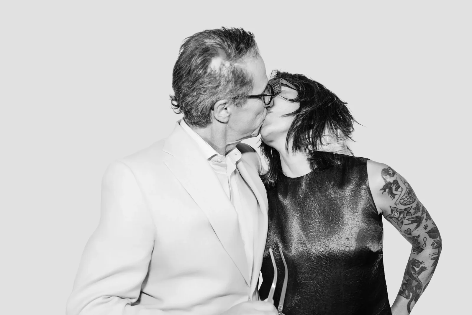 Black and white Glam Booth portrait of a couple sharing a kiss