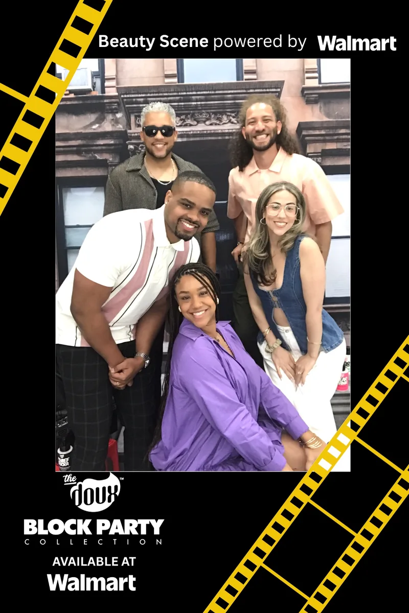 Group of five guests posing on the brownstone stoop backdrop at The Doux Block Party activation