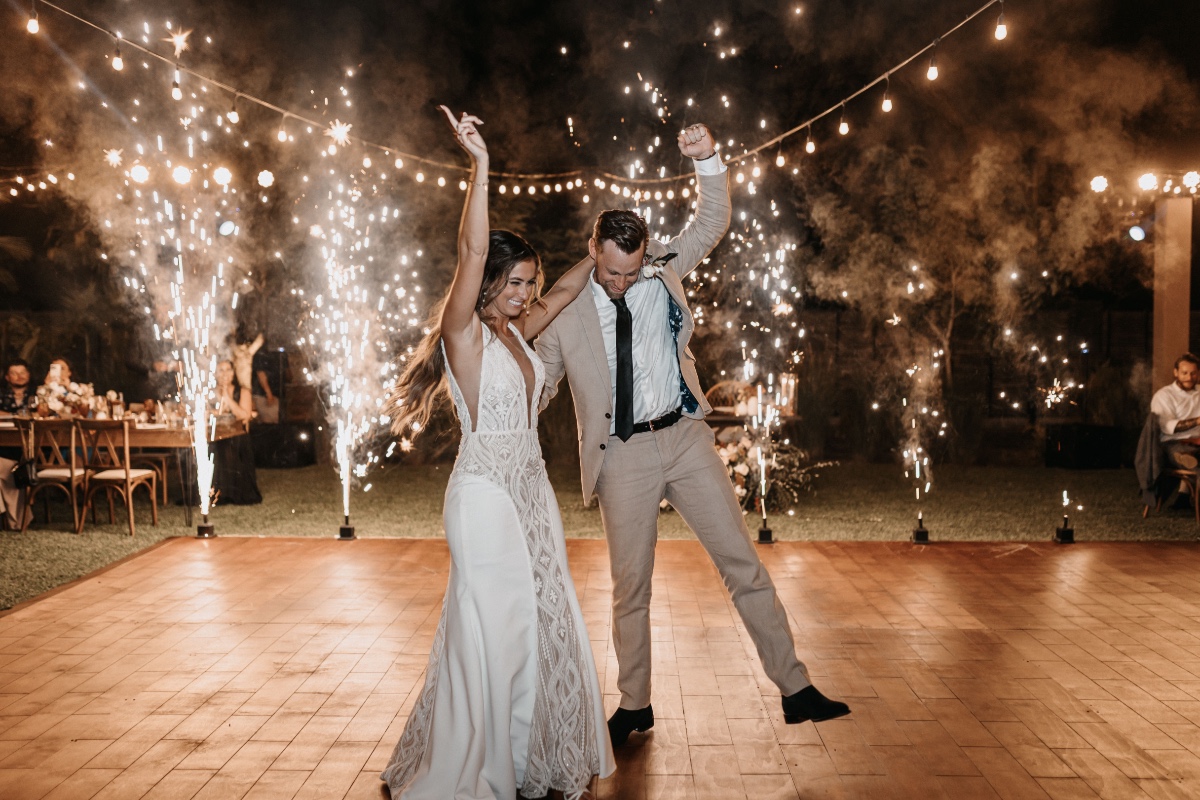 Bride and groom dancing with sparklers at their Baja Luna wedding reception