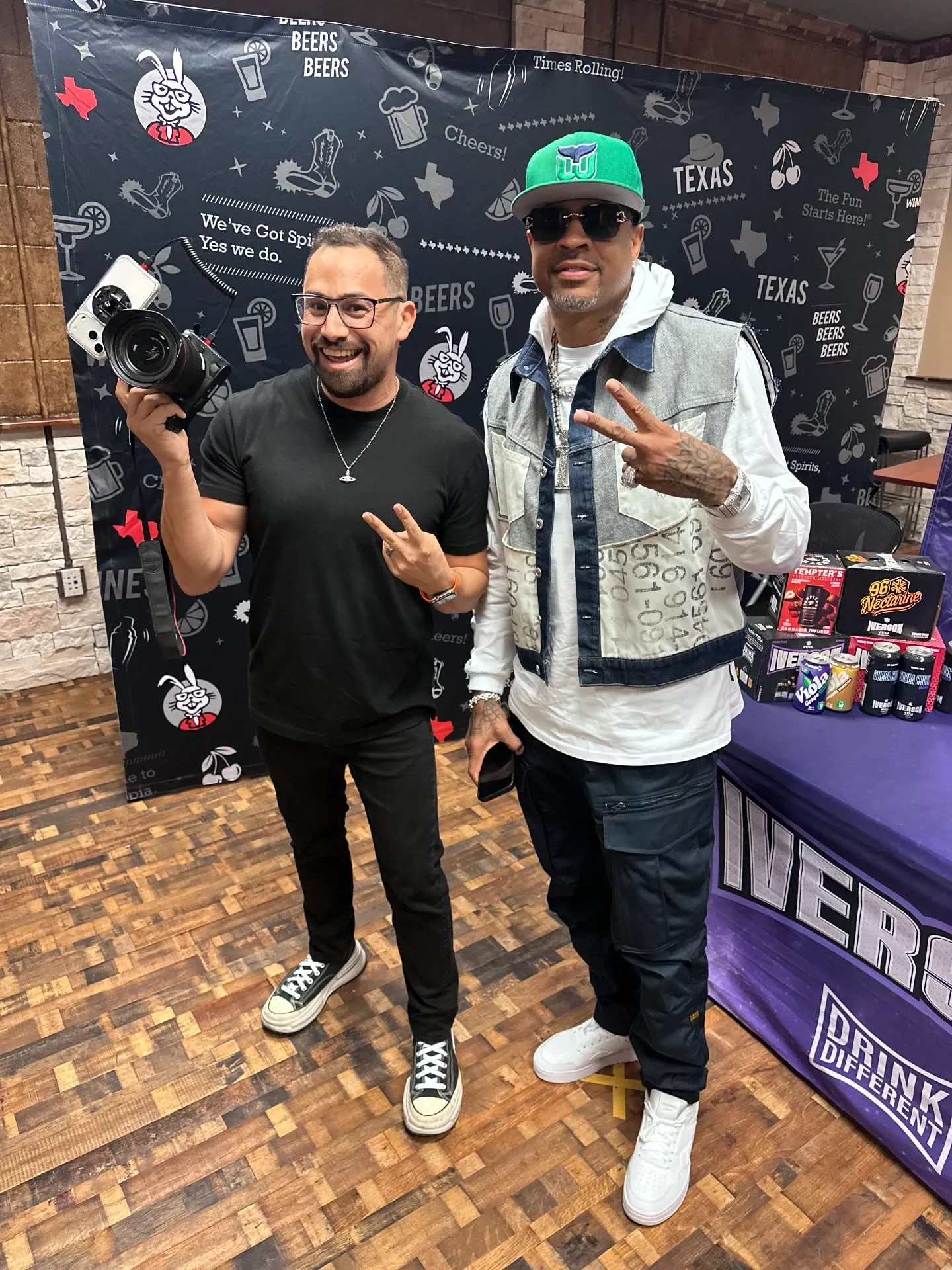 URBN Events photographer posing with a guest at a celebrity meet and greet, DSLR camera in hand