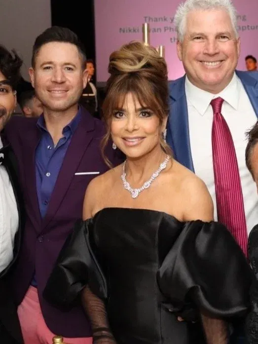 Celebrity guests posing together at a charity gala