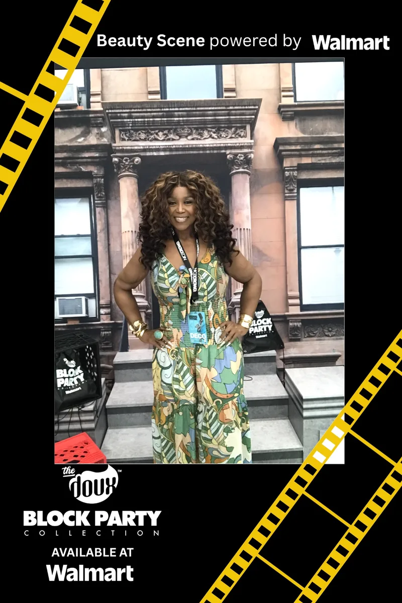 Guest in a printed jumpsuit posing at the ring light photo booth at ABFF Miami