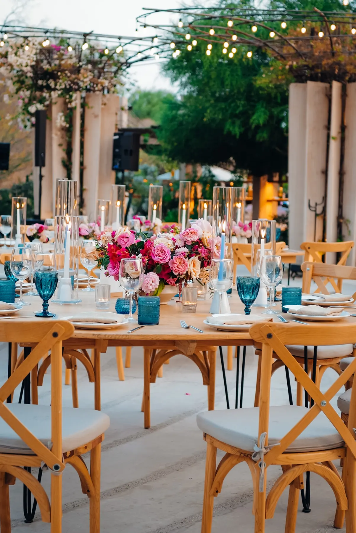 Wedding reception tables with floral centerpieces and warm lighting