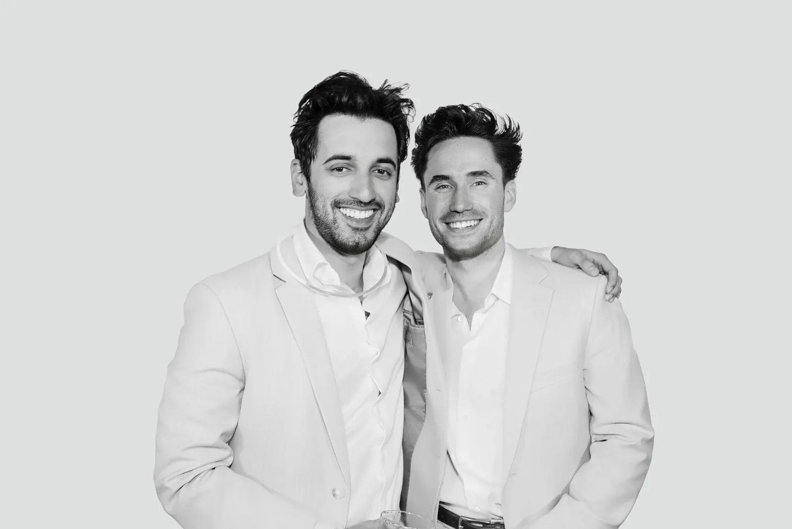 Black and white Glam Booth portrait of two men in light suits