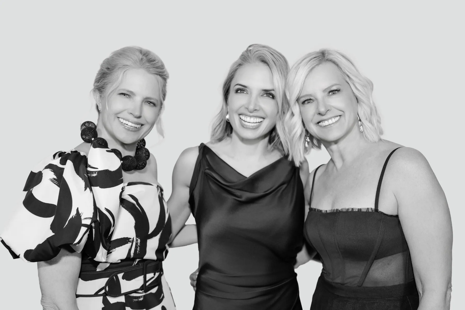 Three women smiling in black and white Glam Booth photo