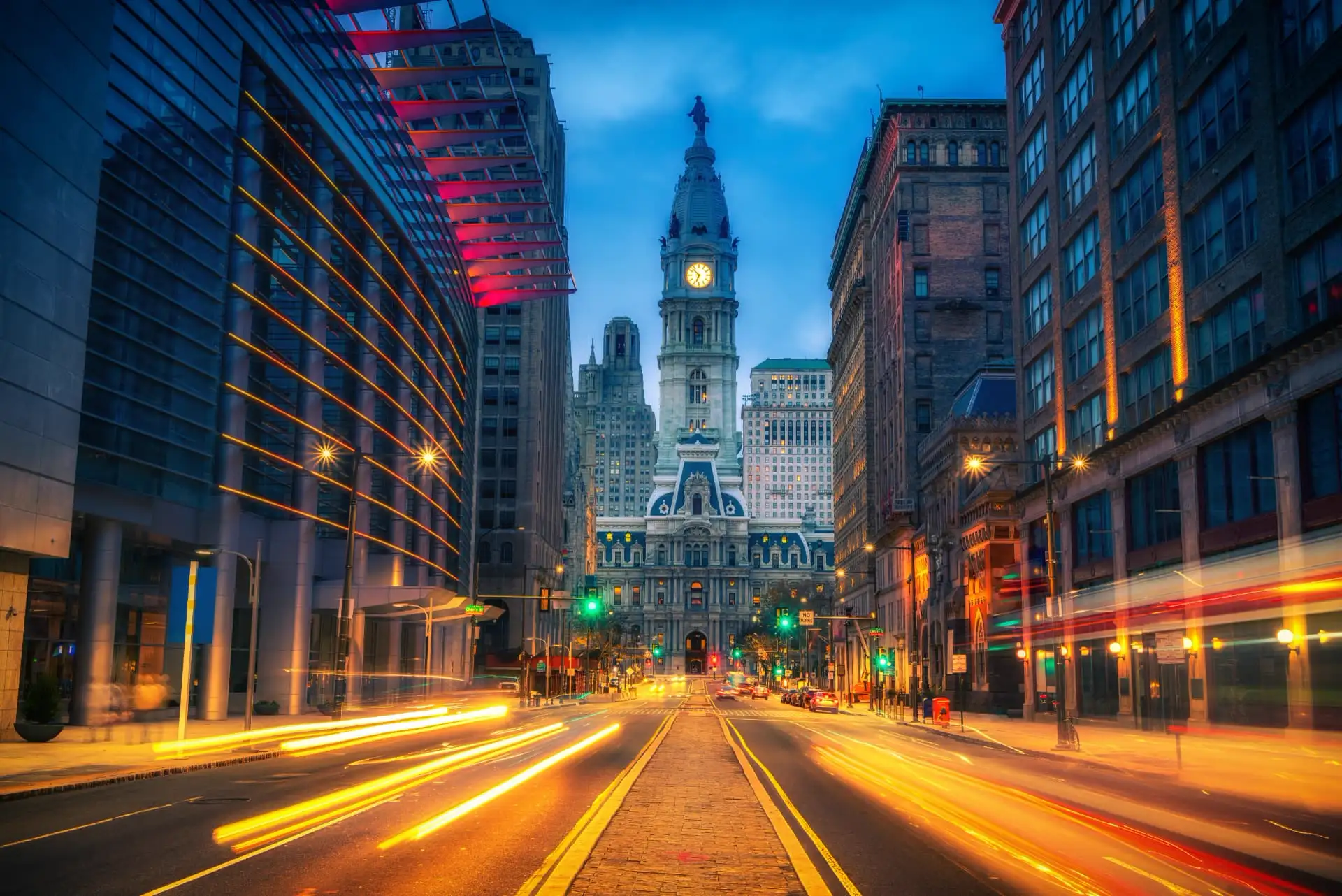 Philadelphia City Hall at dusk seen down Broad Street with light trails