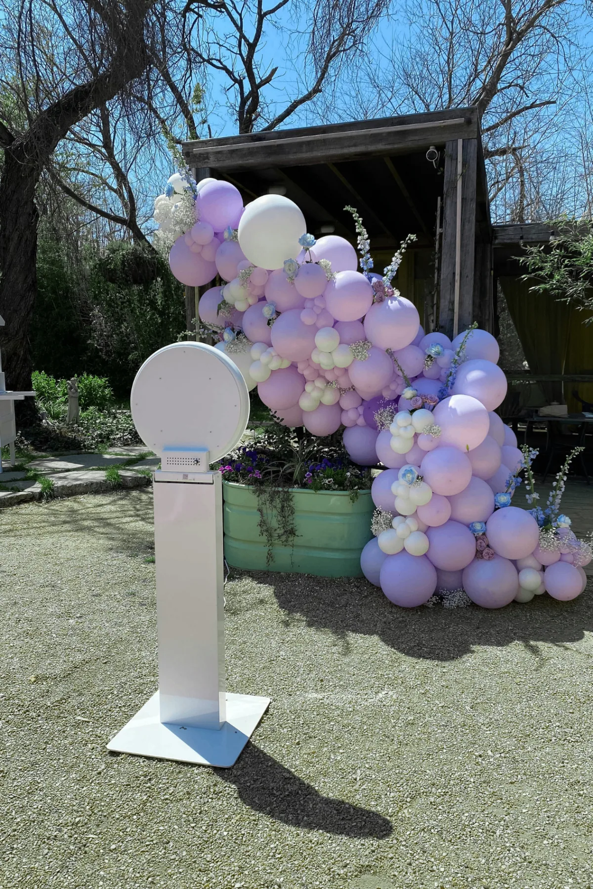 Ring Light Booth set up beside a pastel balloon garland at an outdoor event