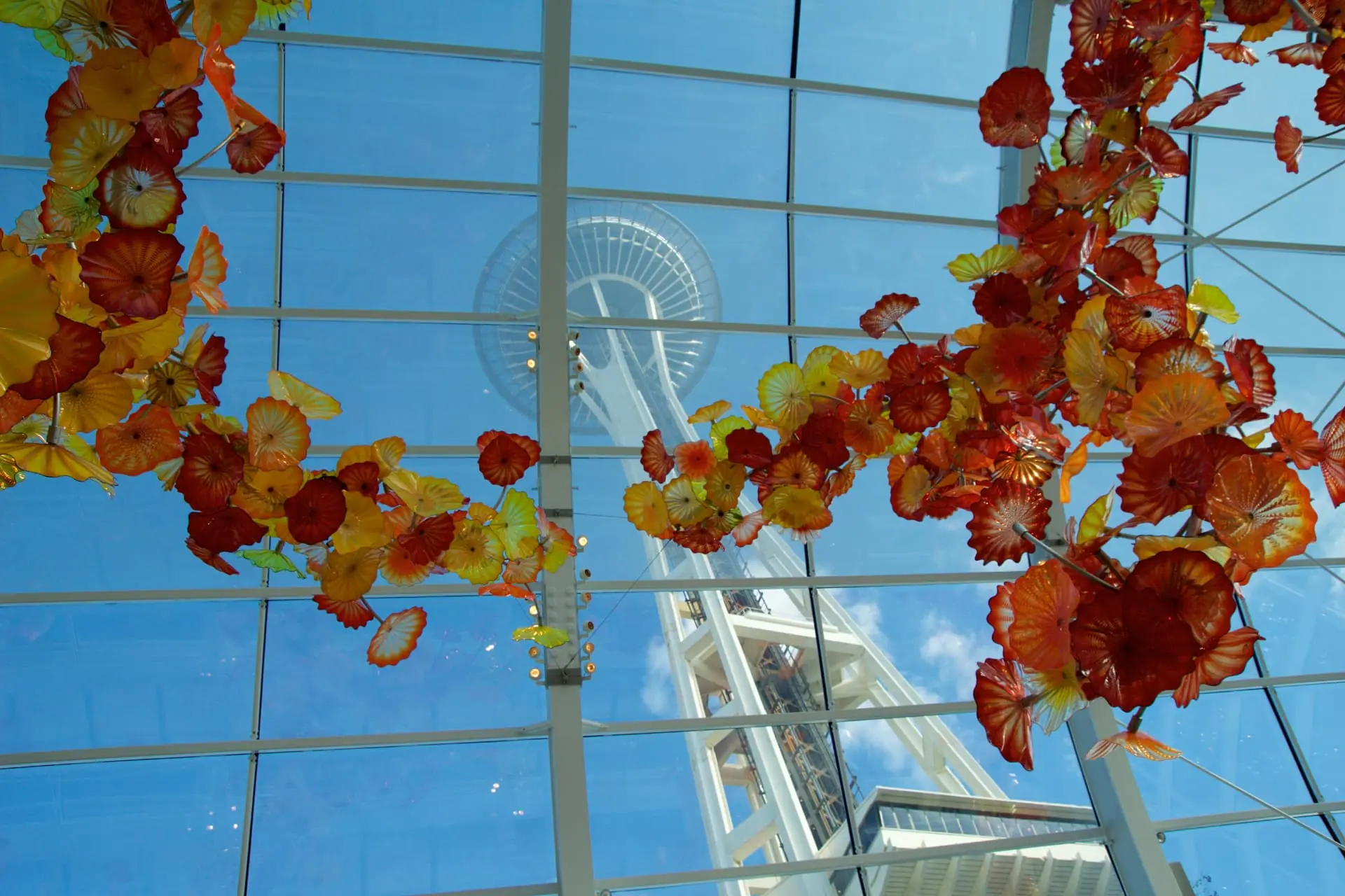 The Space Needle seen through the glass ceiling and blown-glass sculpture at Chihuly Garden and Glass